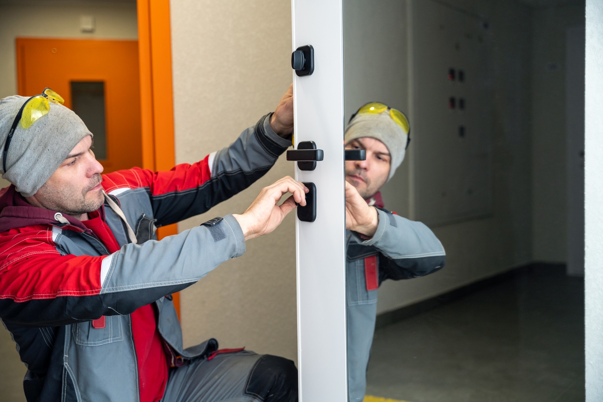 Maintenance man examining front door lock of an apartment in the apartment building